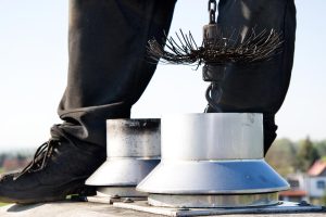Man cleaning a chimney with a brush