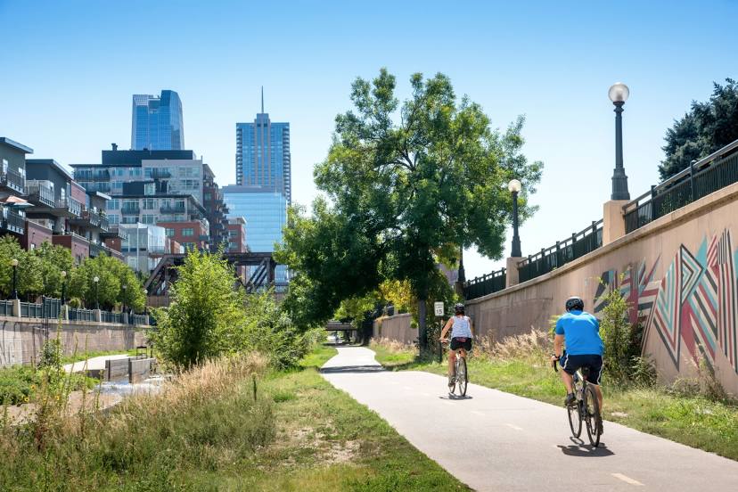 a cityscape with two bikers on the lane