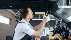 A Man Cleaning The Interior Of The Car
