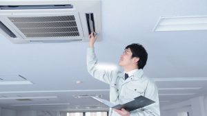 A man checking the air duct