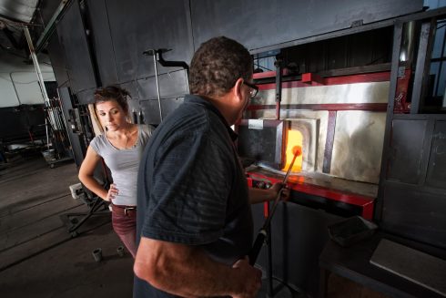This is a picture of a man repairing a furnace.